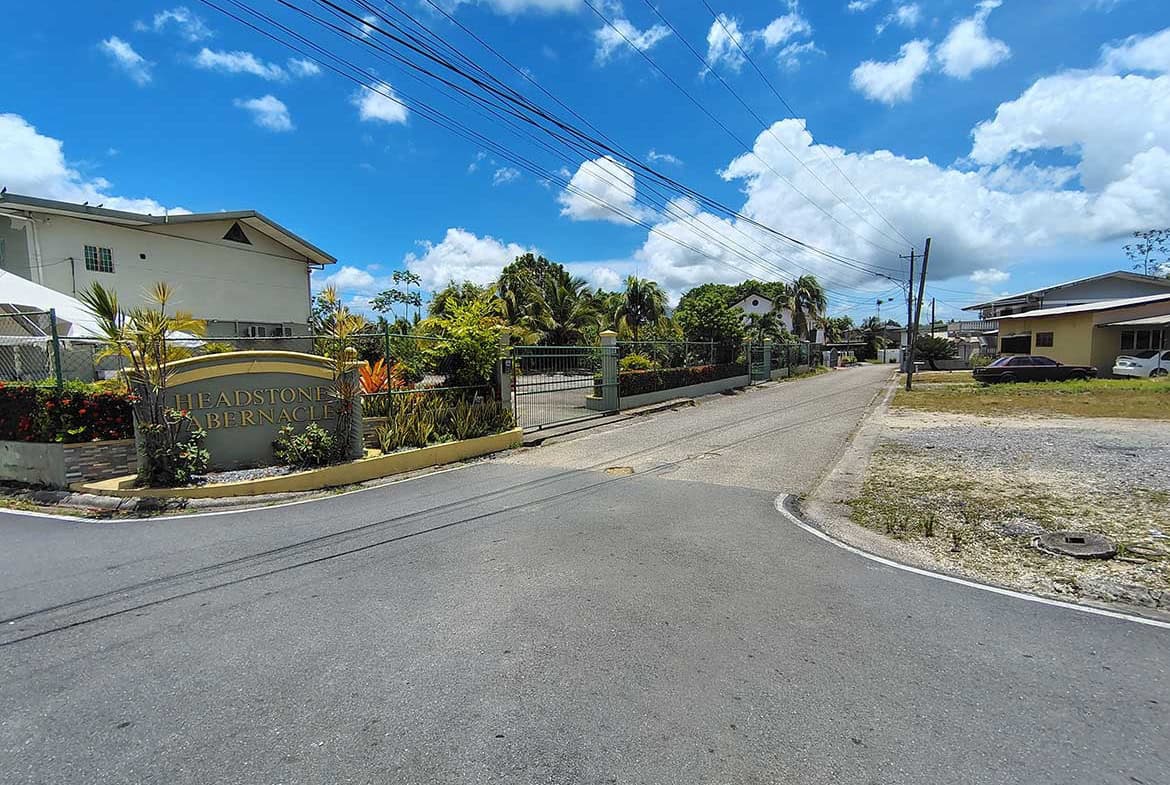 Cornerstone- Residential street view on Ajim Baksh Road with houses and power lines.