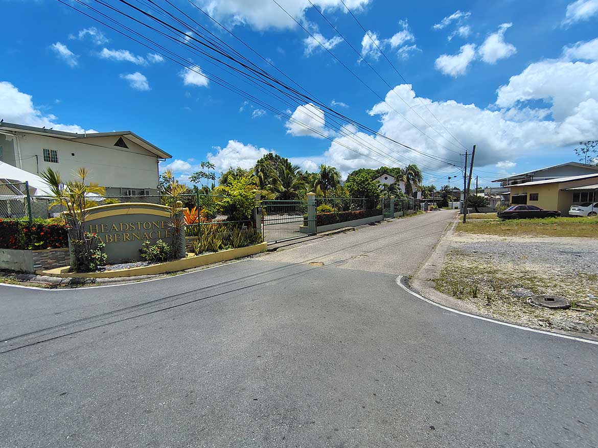Cornerstone™ on Ajim Baksh Road Cornerstone- Residential street view on Ajim Baksh Road with houses and power lines.