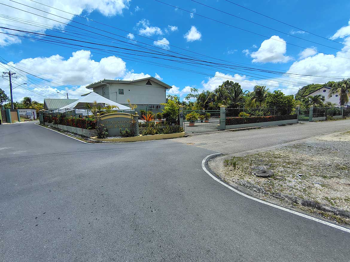 Cornerstone™ Property on Ajim Baksh Road Cornerstone- Residential property on Ajim Baksh Road with garden and driveway.