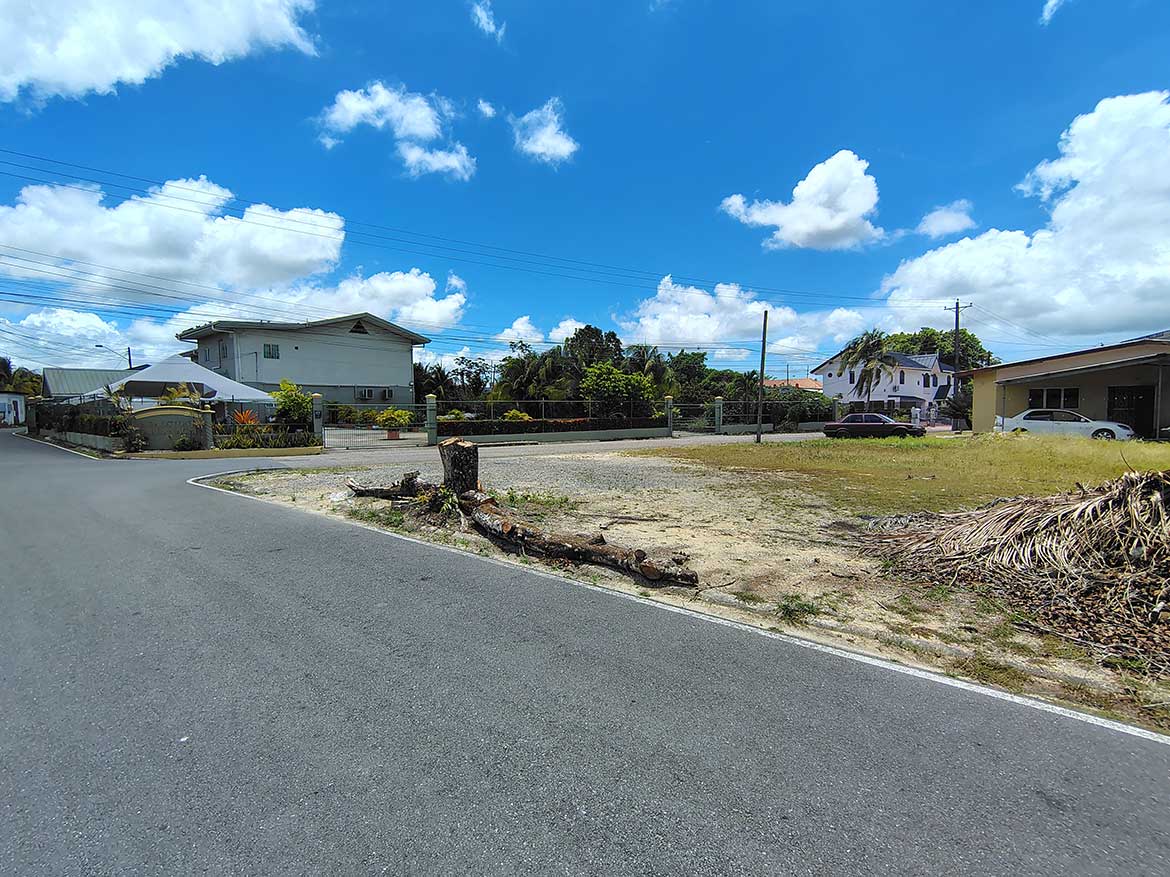 Off Ajim Baksh Road – Cornerstone™ Cornerstone- Residential street scene on Ajim Baksh Road with houses and blue sky.