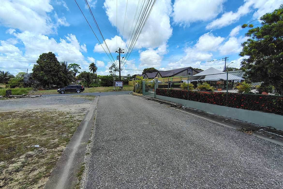 Cornerstone- Street view of Ajim Baksh Road with houses and power lines.