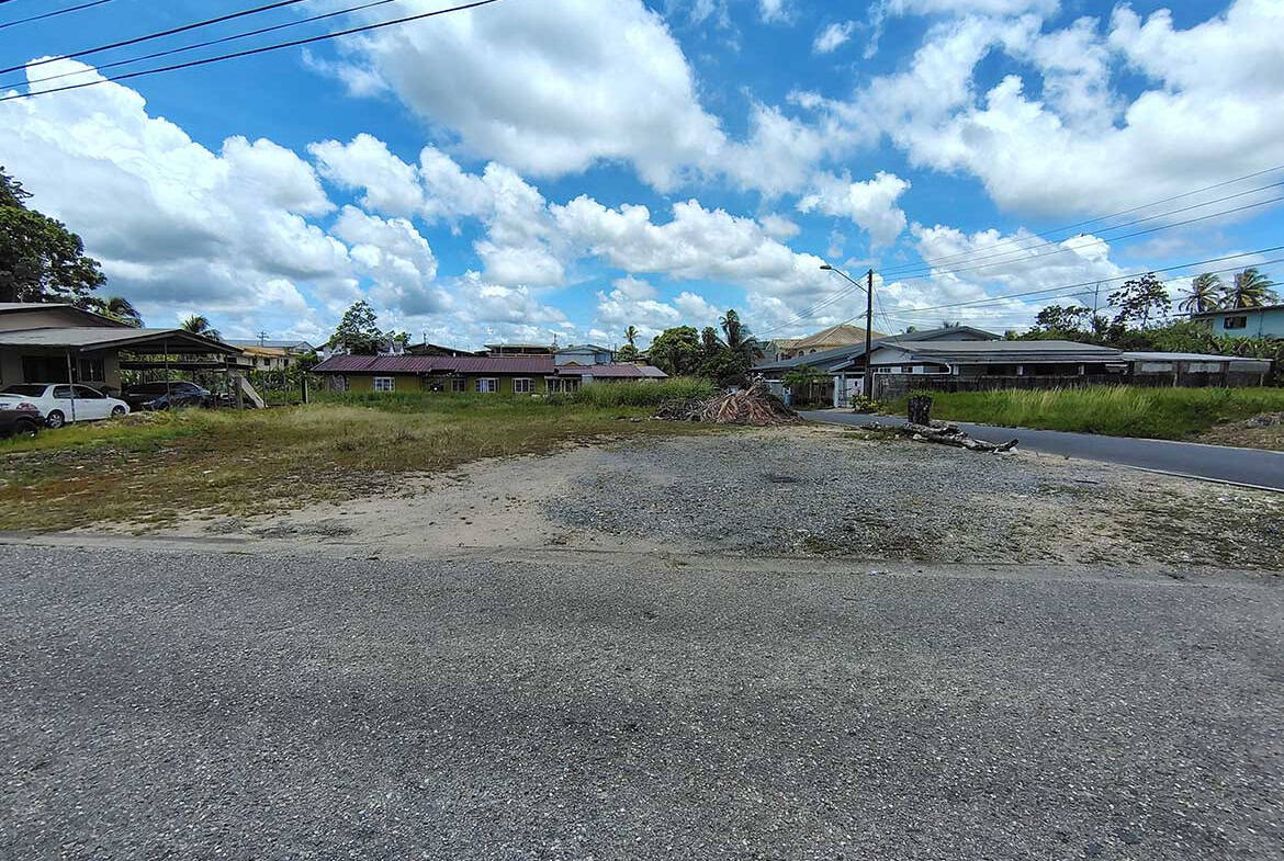 Cornerstone- Vacant land on Off Ajim Baksh Road with houses in the background.
