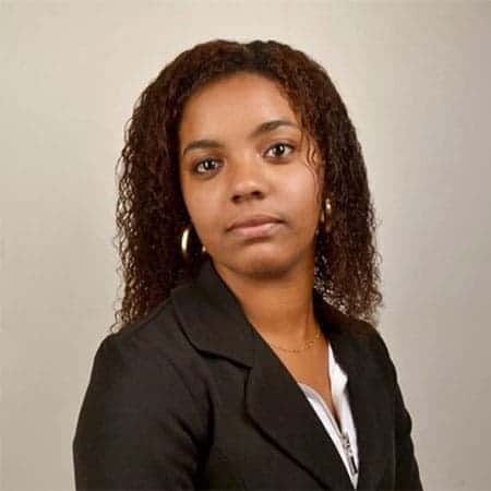 Cornerstone- Confident woman with curly hair in professional attire for Cornerstone.