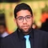 Cornerstone- Business professional wearing glasses and a suit with a blue tie.