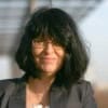 Cornerstone- Woman with black hair and glasses smiling outdoors at Cornerstone.