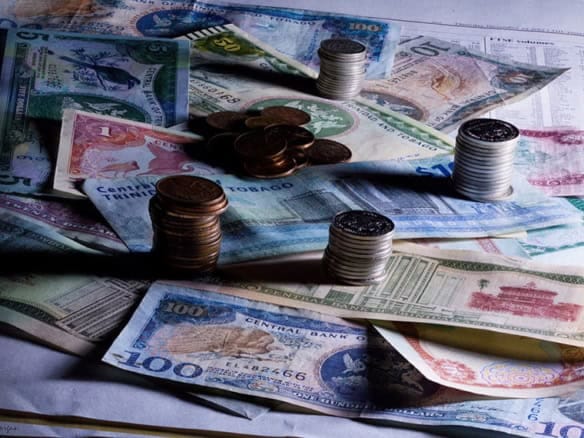 Cornerstone- Stacks of various international banknotes and coins for savings and investment.