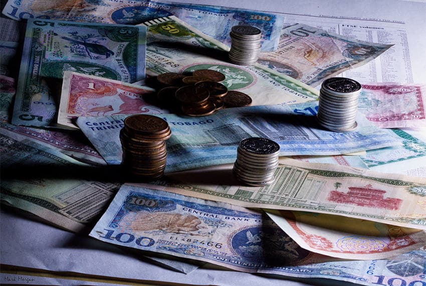 Cornerstone- Stacks of various international banknotes and coins for savings and investment.