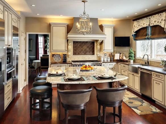 Cornerstone- Spacious kitchen with island, cabinetry, and modern appliances.