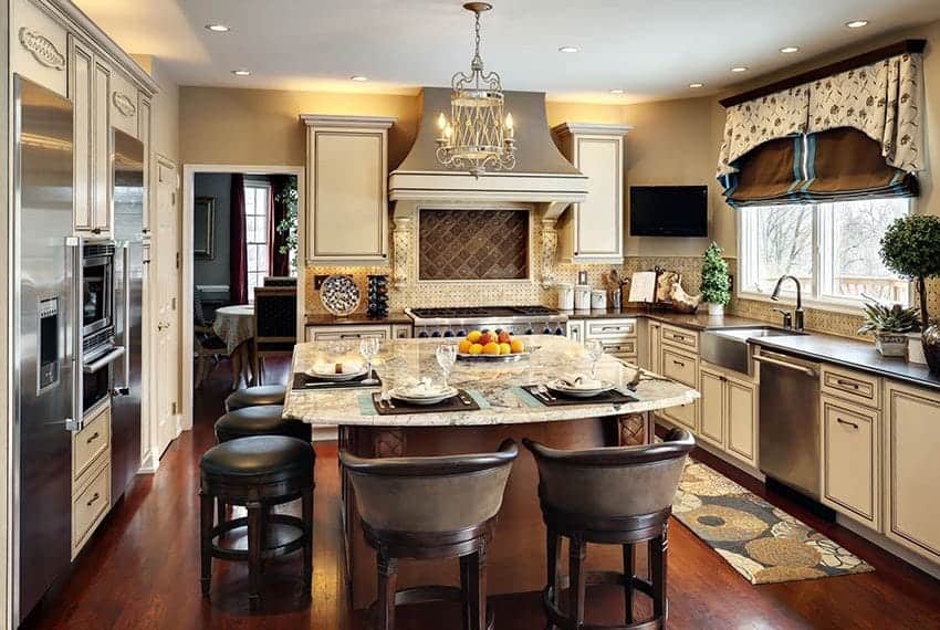 Cornerstone- Spacious kitchen with island, cabinetry, and modern appliances.