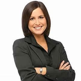 Cornerstone- Confident businesswoman smiling with arms crossed, professional appearance.