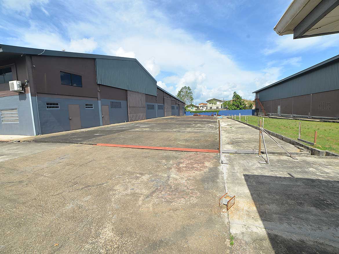 O’Meara Industrial Area in Trinidad Cornerstone- Empty industrial lot with warehouses in O'Meara, Trinidad.