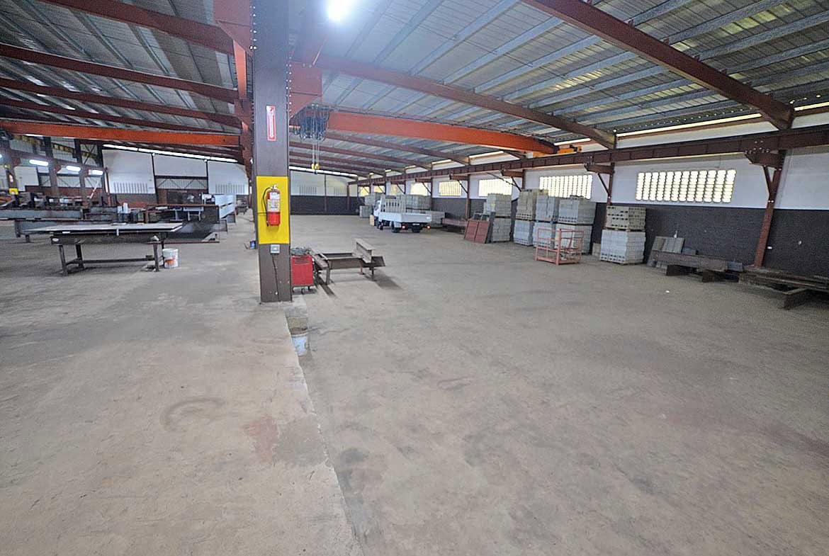 Cornerstone- Spacious industrial warehouse with storage racks and work areas at e TecK Building.