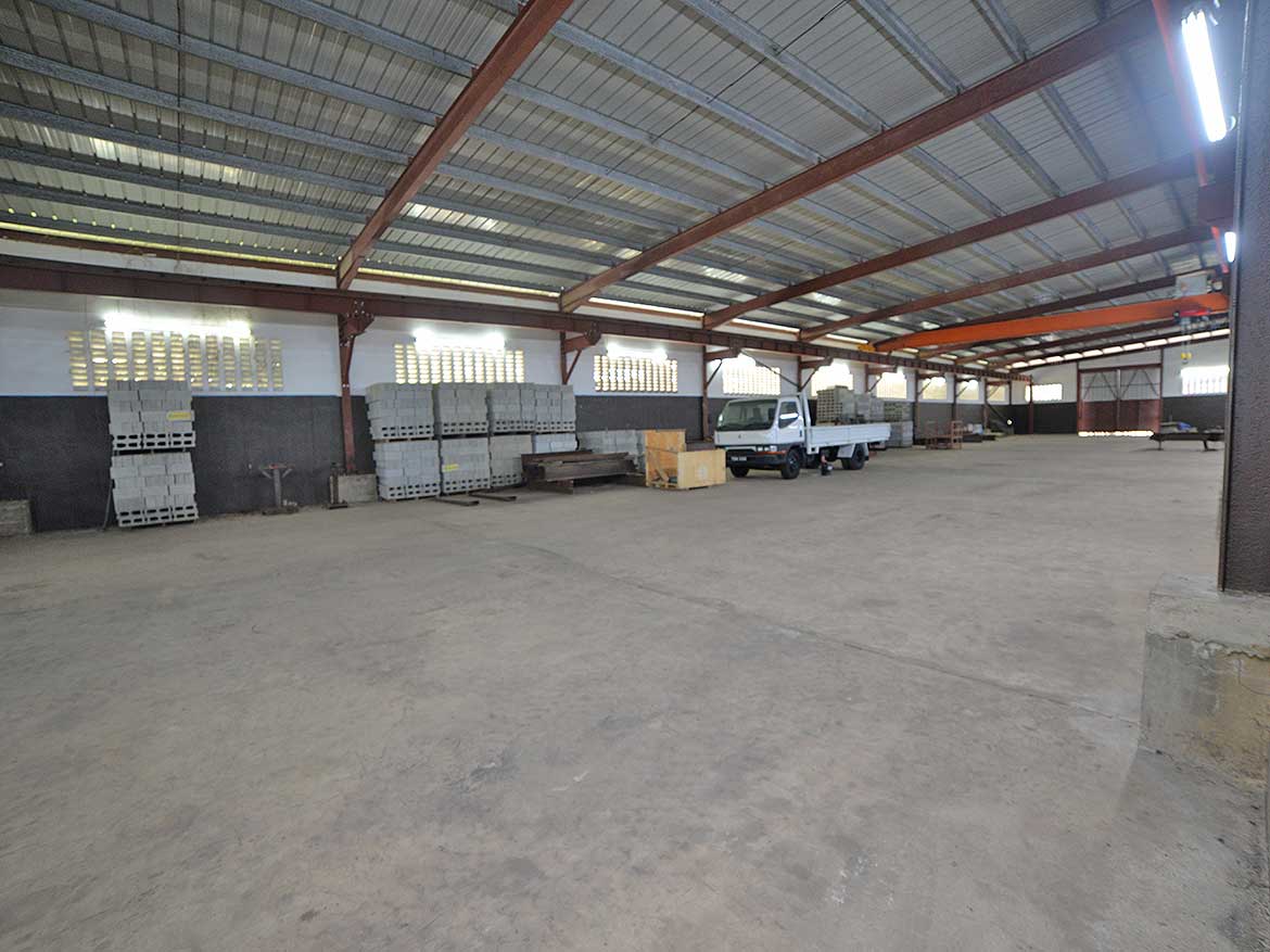 e TecK Building O’meara Warehouse Cornerstone- Spacious warehouse at e TecK Building O'meara with construction materials.