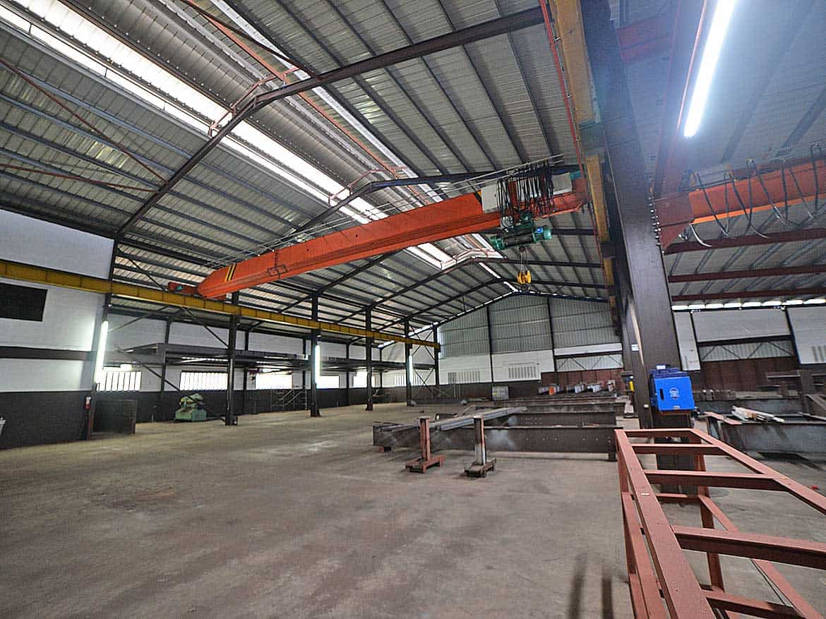 Industrial Crane at e TecK Building Cornerstone- Large orange overhead crane inside e TecK Building in O'meara.