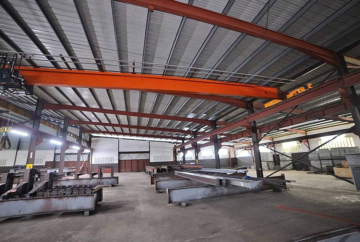 Cornerstone- Industrial interior with overhead cranes and steel structures at e TecK Building O'meara.