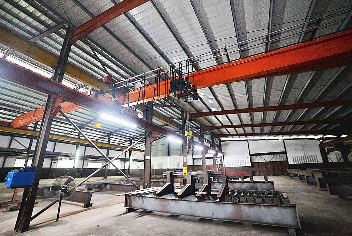 Cornerstone- Interior view of industrial equipment and overhead crane at e TecK Building.