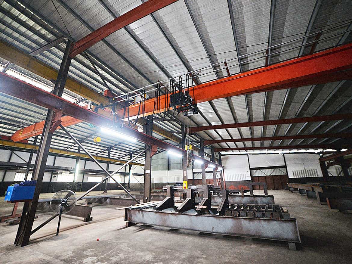 Industrial Facility at e TecK Building Cornerstone- Interior view of industrial equipment and overhead crane at e TecK Building.