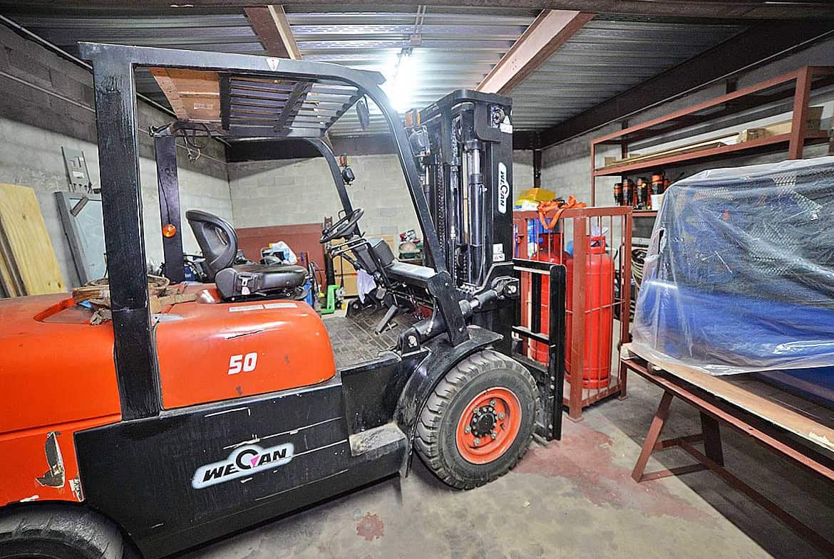Cornerstone- Forklift inside e TecK Building at Cornerstone with storage shelves and equipment.