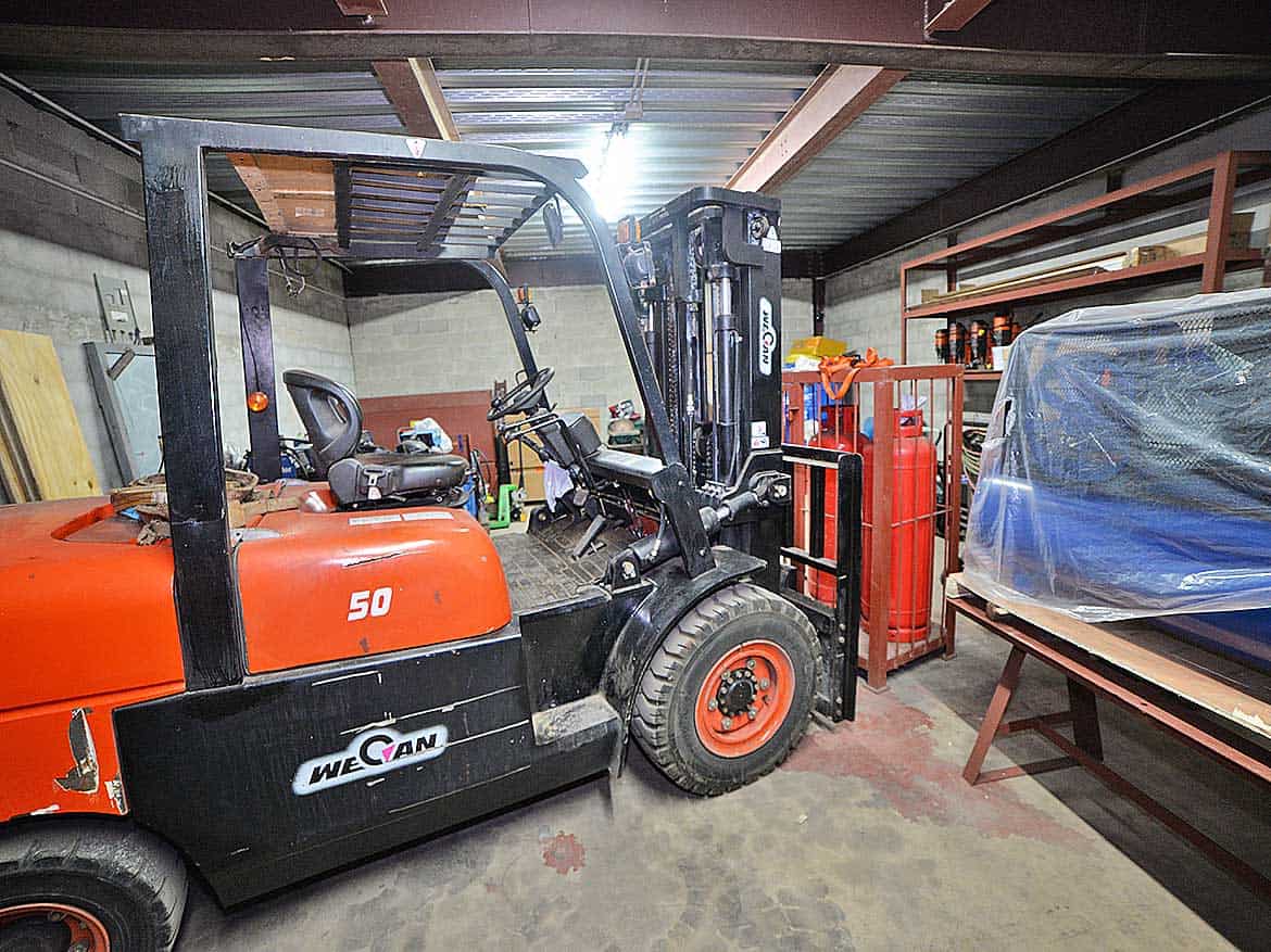 Cornerstone™ e TecK Building Equipment Cornerstone- Forklift inside e TecK Building at Cornerstone with storage shelves and equipment.