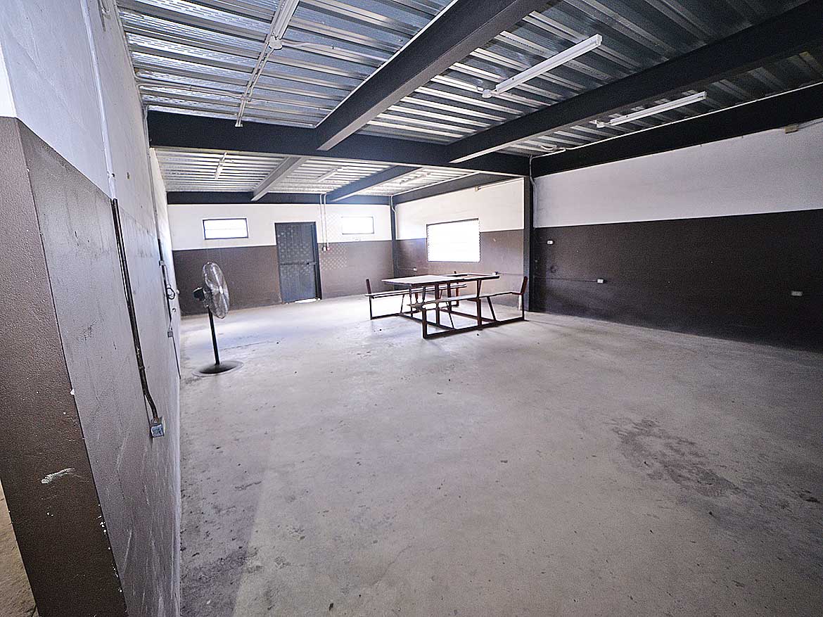 Industrial Warehouse Space at Cornerstone Cornerstone- Spacious industrial warehouse interior with concrete floor and metal roof.