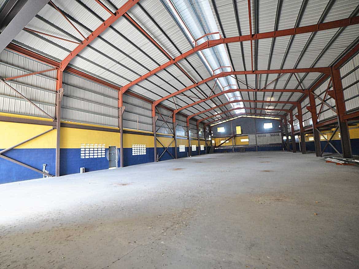 Interior of e TecK Building in O’meara Cornerstone- Spacious industrial warehouse interior with high ceilings and metal framework.