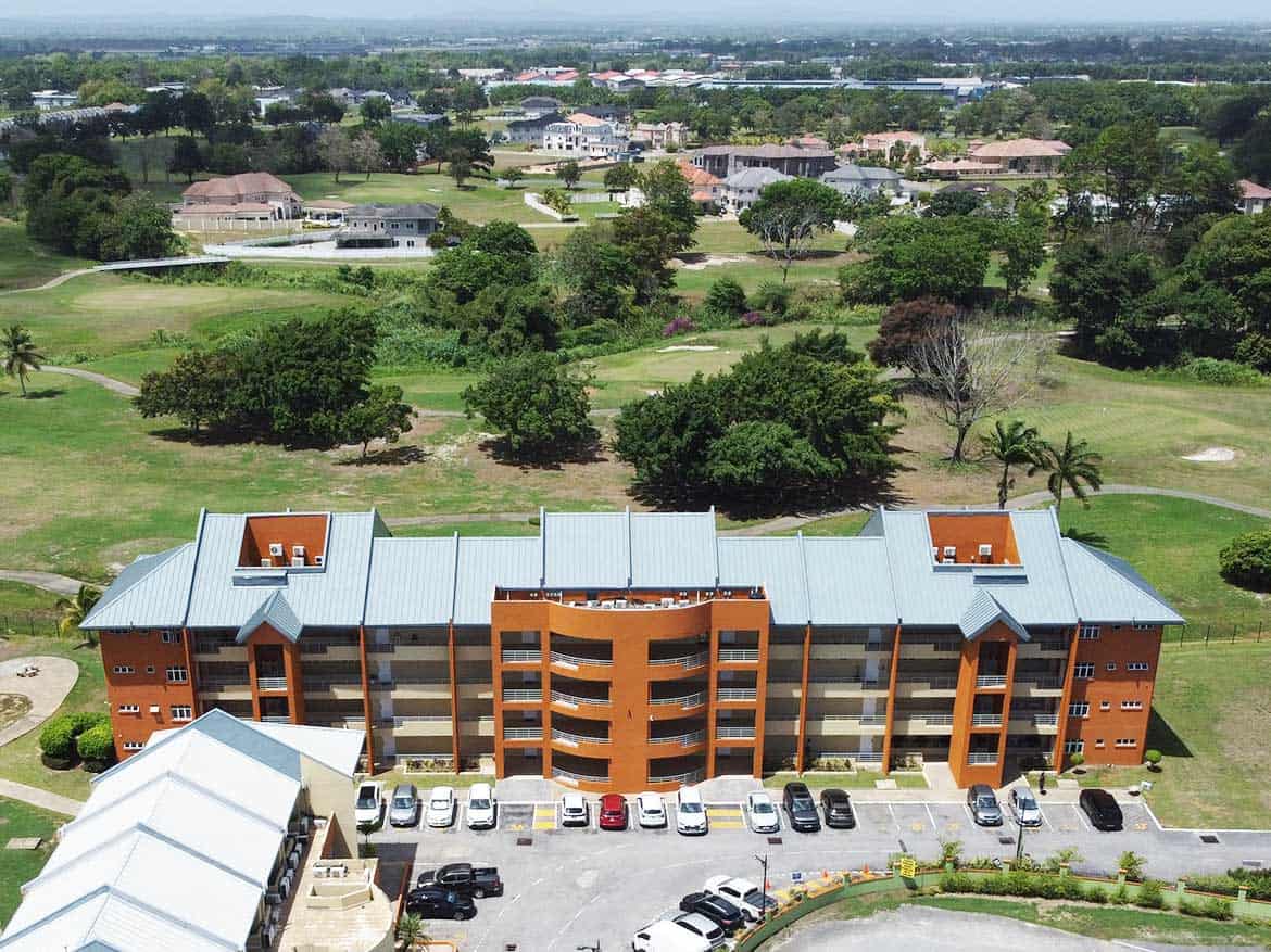 Cornerstone™ Residential Complex Aerial view of Cornerstone™ residential building with parking lot and green landscape.