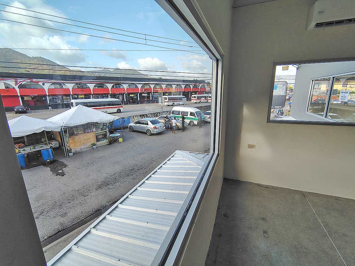 Commercial Spaces in Curepe Cornerstone- View of Curepe train station and parking lot from inside office.