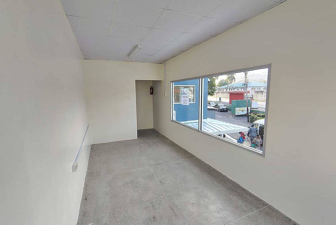Cornerstone- Empty commercial space with large window in Curepe, Trinidad.