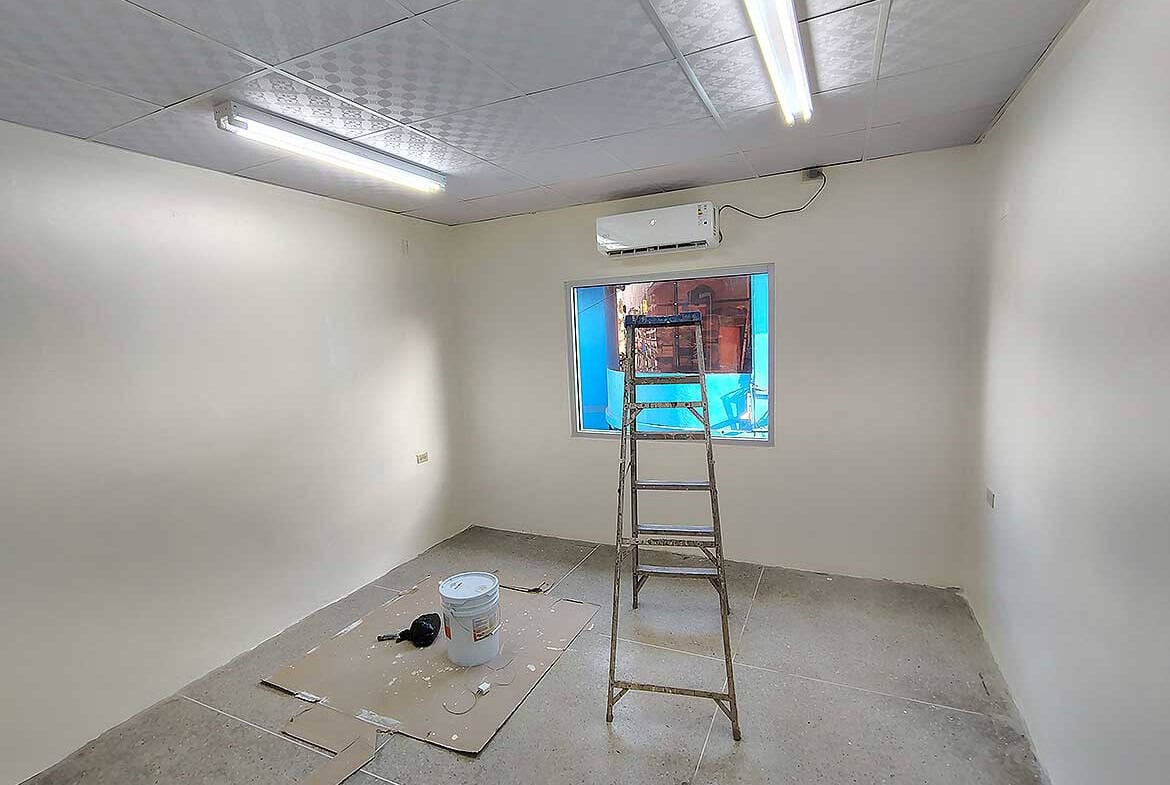 Cornerstone- Empty commercial room with ladder and construction tools in Curepe.