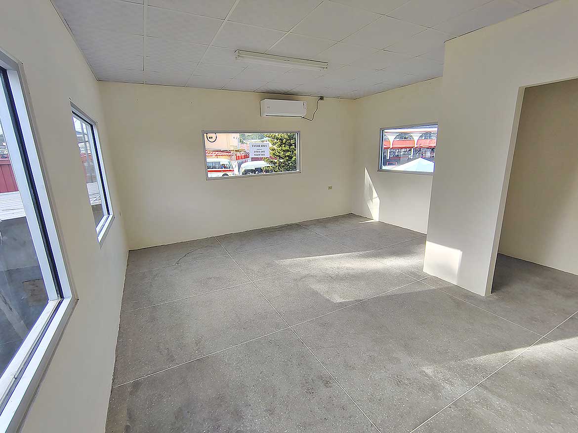 Commercial Space Interior in Curepe Cornerstone- Empty commercial space with large windows in Curepe for lease or sale.