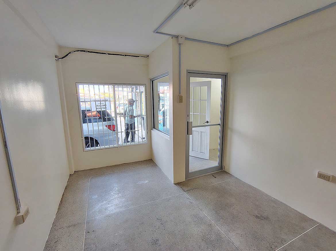 Commercial Space Interior Curepe Cornerstone- Empty commercial space with large windows and glass door in Curepe.