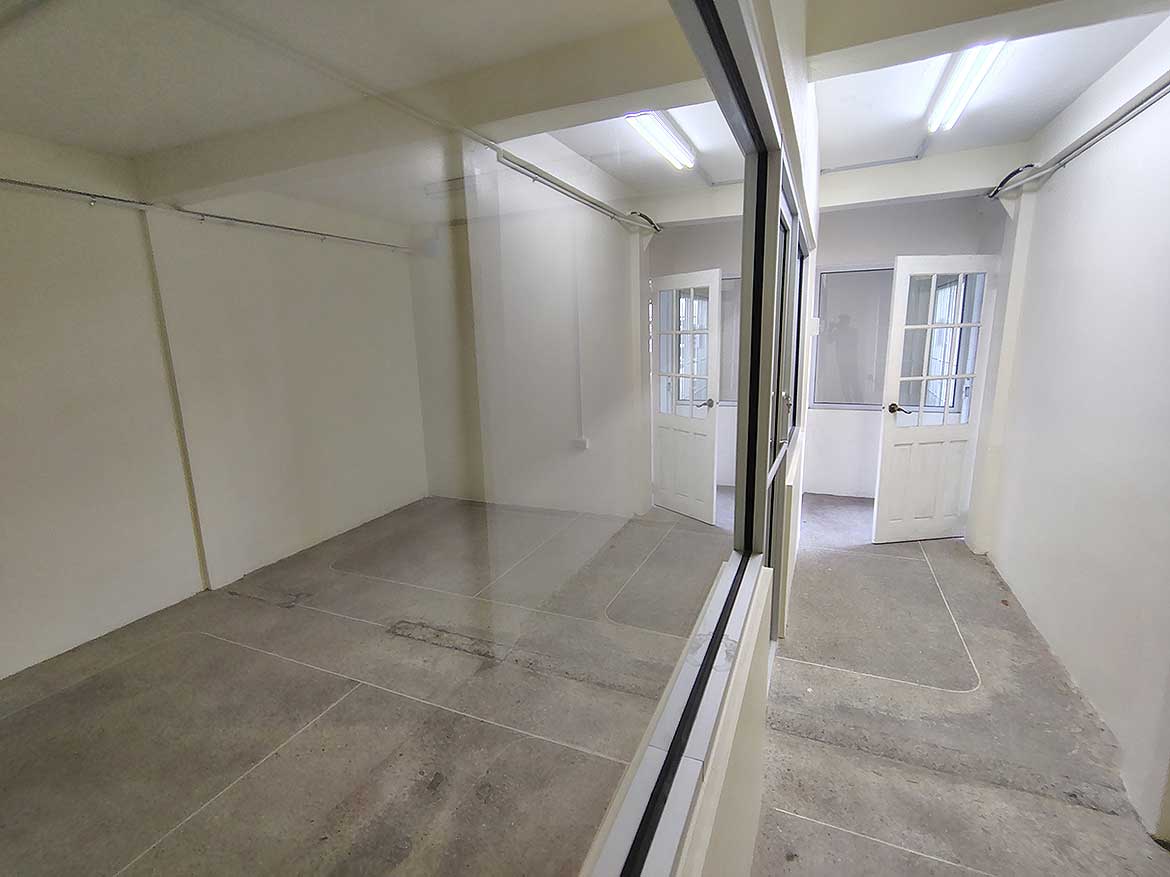 Commercial Space Interior at Cornerstone Cornerstone- Empty commercial space with glass partition and white walls in Curepe.