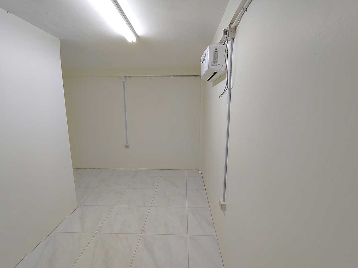 Commercial Space in Curepe Cornerstone- Empty commercial space with white walls and tiled floor in Curepe.