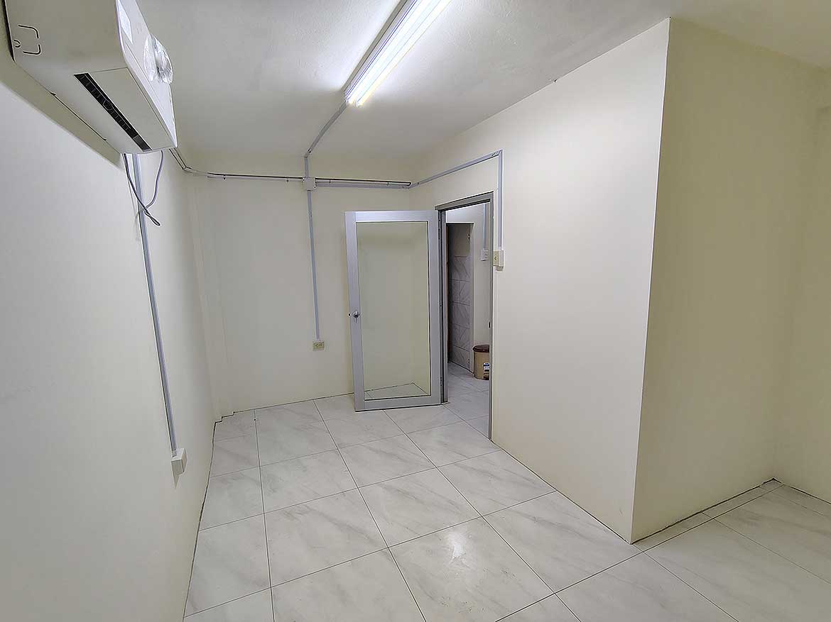 Commercial Space Interior at Cornerstone Empty commercial space interior with white walls and tiled floor in Curepe.