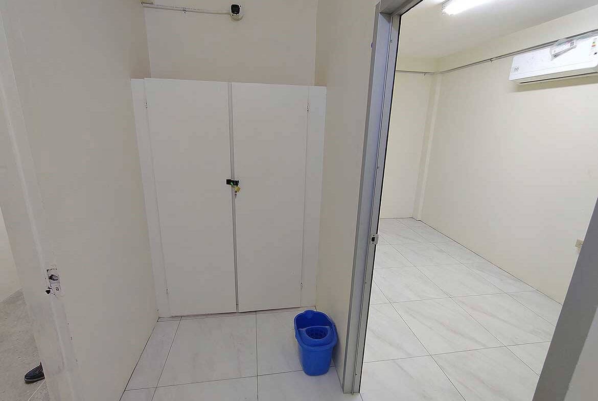 Cornerstone- Empty commercial room with white walls and tiled floor in Curepe.