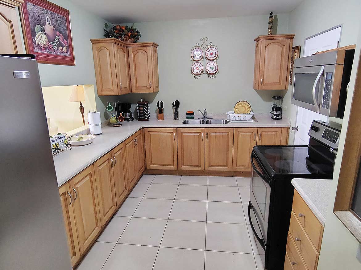 Cornerstone™ Kitchen at EastGate on the Greens Spacious kitchen with wooden cabinets and modern appliances at EastGate on the Greens.