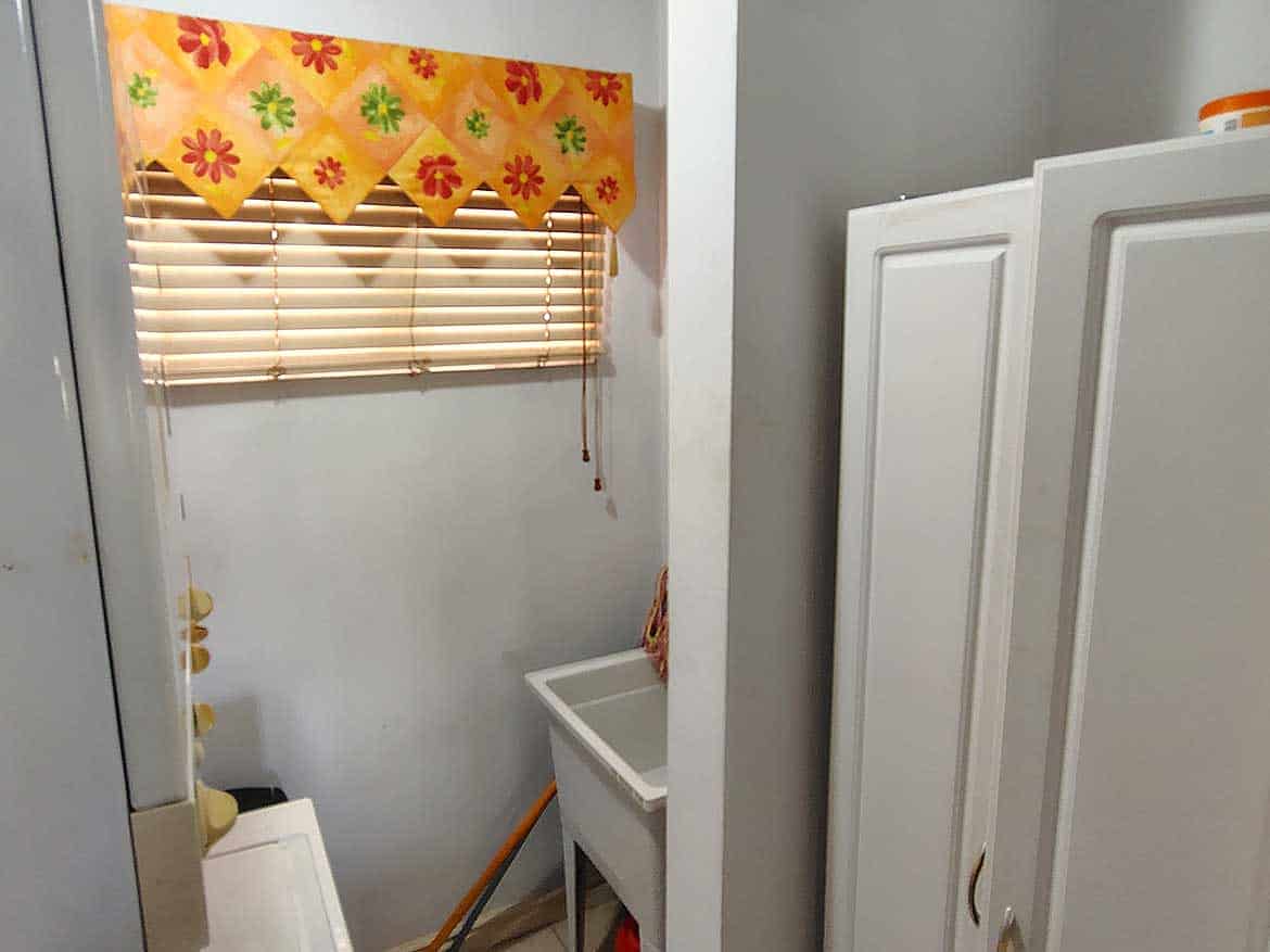 EastGate on the Greens Laundry Area Laundry room with window, colorful valance, and utility sink.