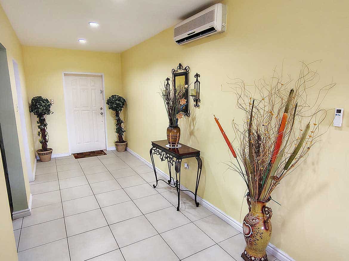 Cornerstone™ EastGate on the Greens Interior view of EastGate on the Greens with decorative plants and wall mirror.