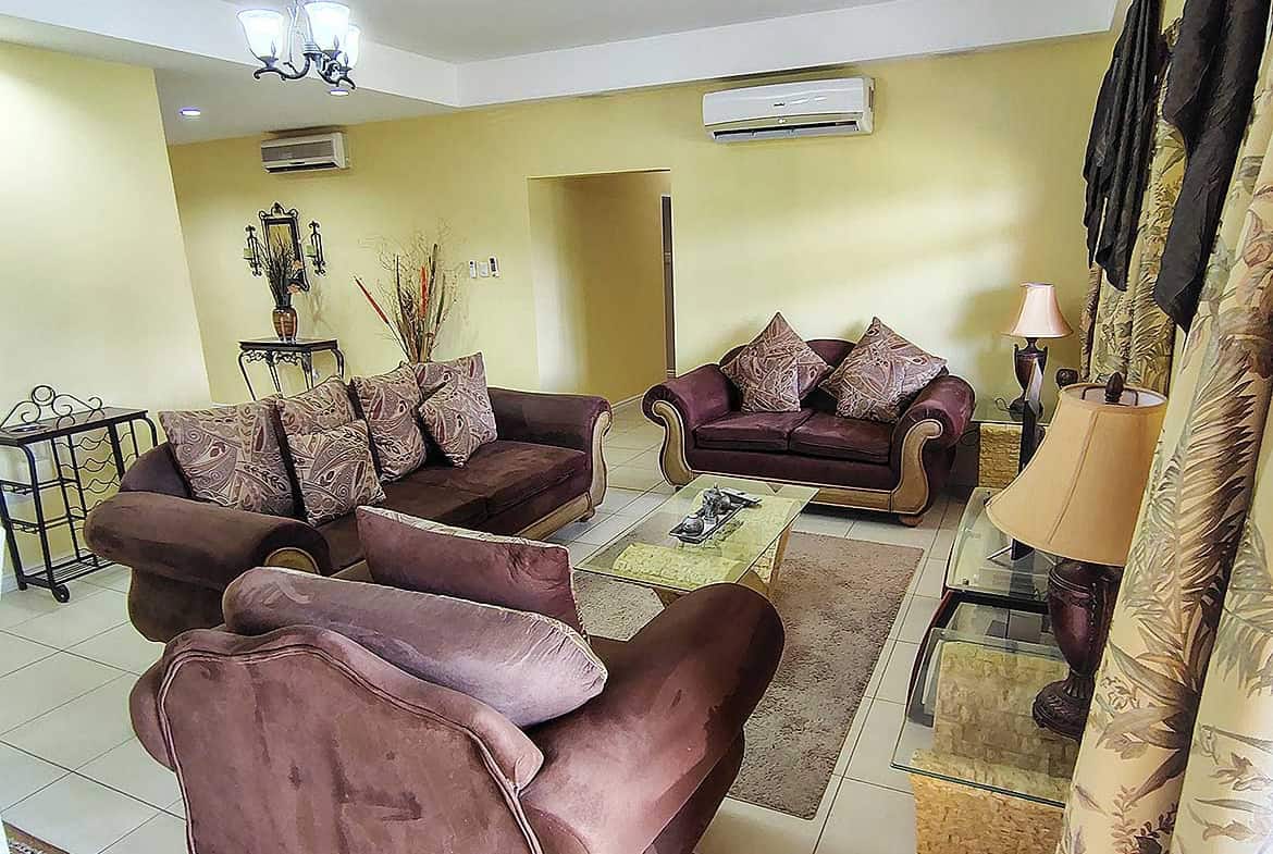 Spacious living room with plush sofas, coffee table, and decorative lighting at Cornerstone.