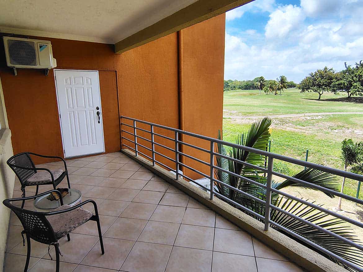 Cornerstone™ Balcony View of EastGate on the Green Balcony with chairs overlooking lush green golf course at EastGate on the Greens.