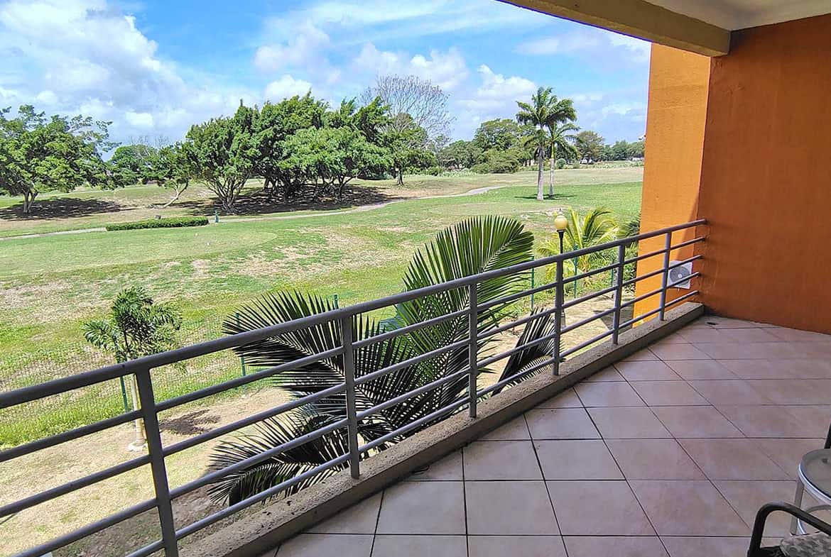 Balcony view overlooking lush green landscape at Cornerstone™ EastGate on the Greens.