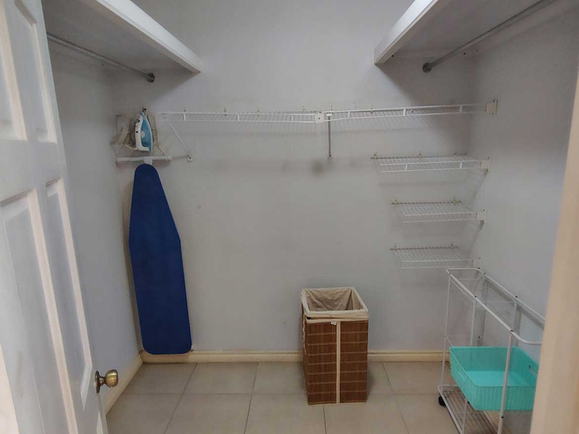 Spacious Closet at EastGate on the Greens Empty closet with shelves, ironing board, and laundry basket at EastGate on the Greens.