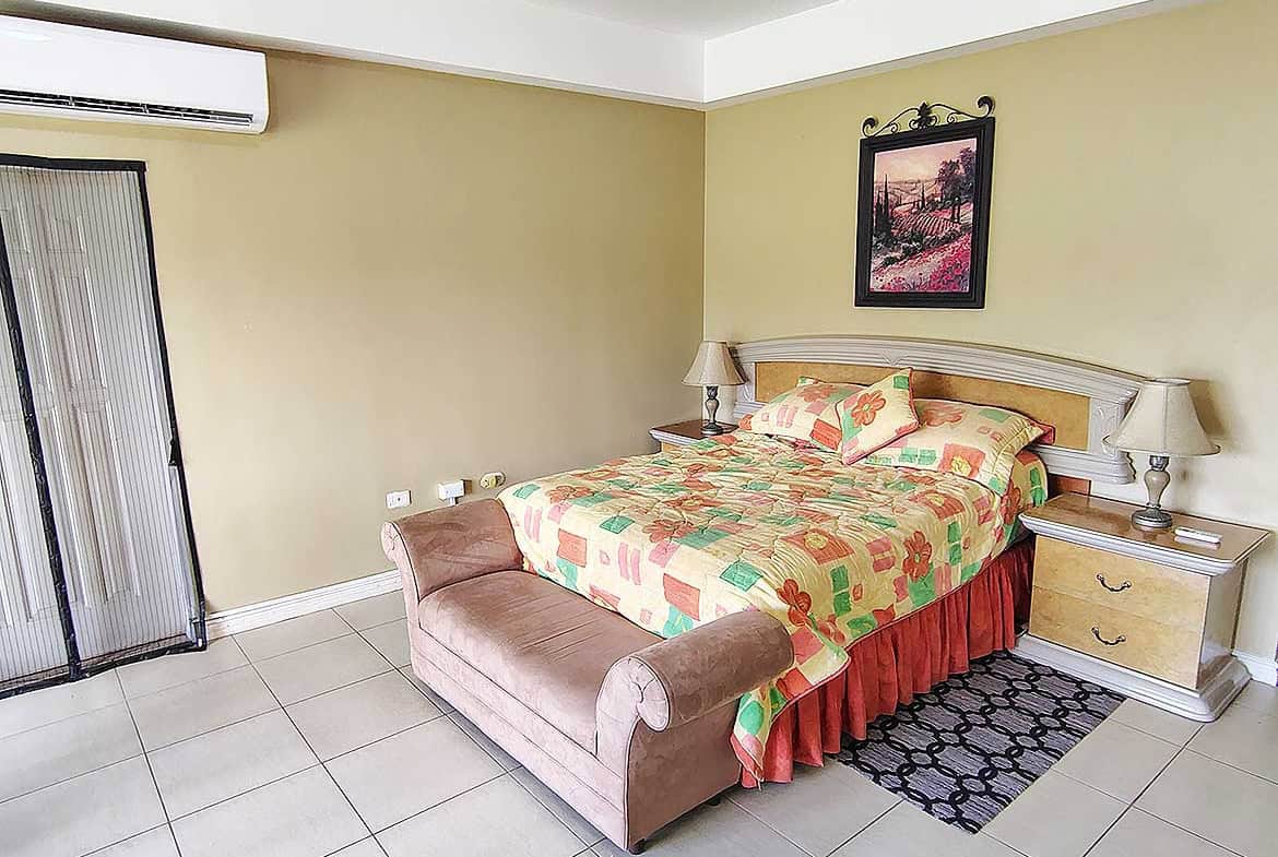 Cozy bedroom with colorful bedding and a large bed at EastGate on the Greens.