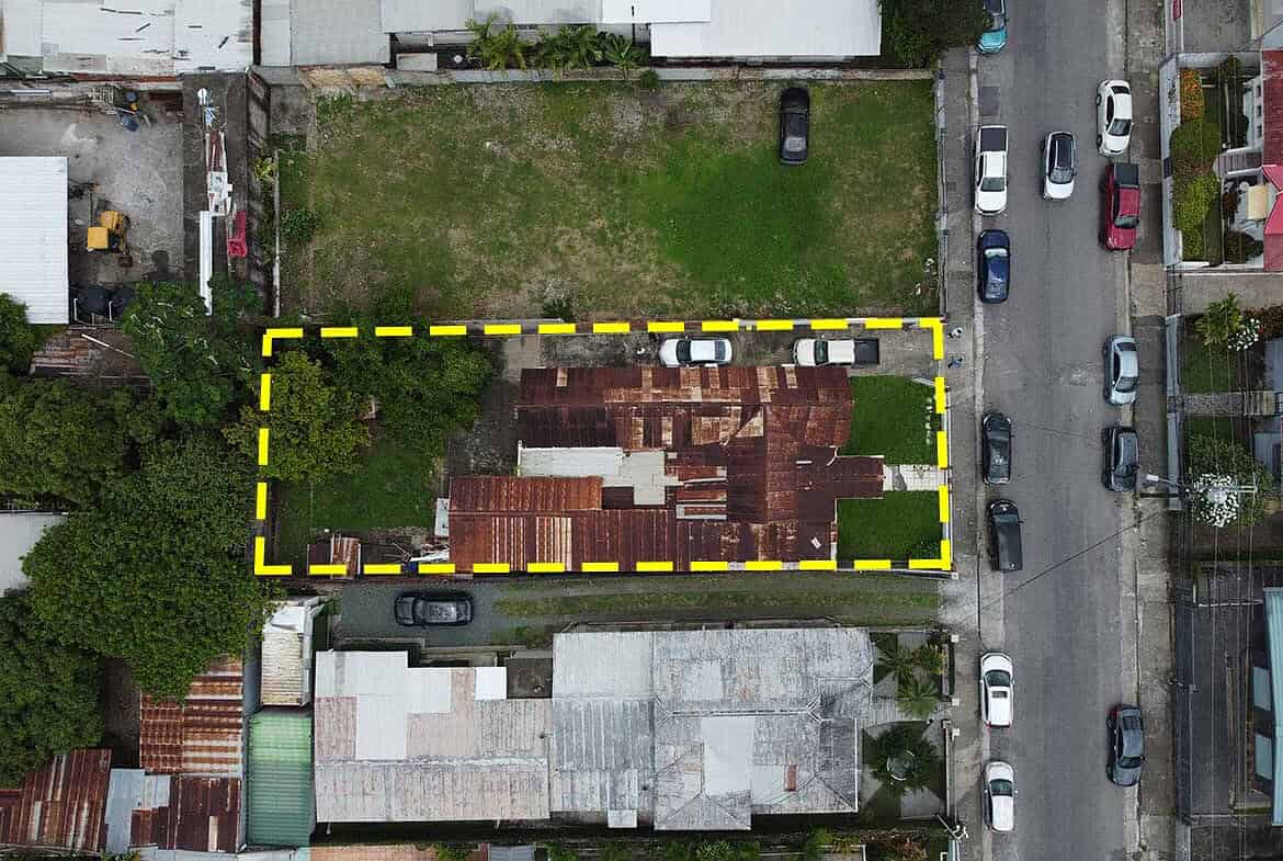 Cornerstone- Aerial view of a property on Carlos Street, Woodbrook, with a yellow boundary outline.
