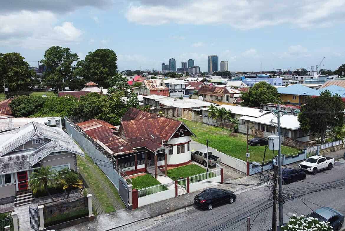 Cornerstone- Residential homes on Carlos Street, Woodbrook with city skyline in background.