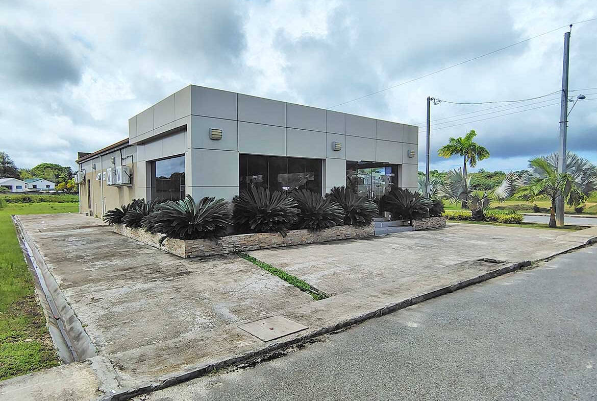 Modern commercial building with landscaping in Ella Vista Gardens, Trinidad.