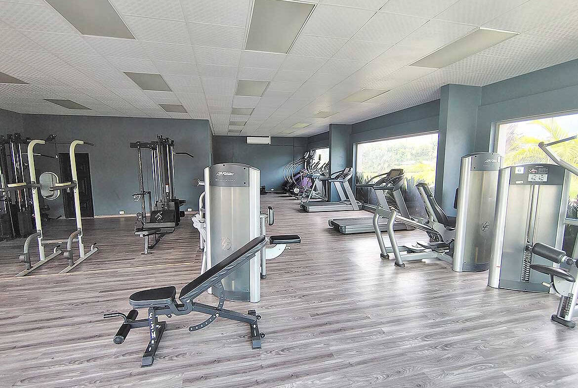 Modern gym with cardio and strength equipment at Ella Vista Gardens.