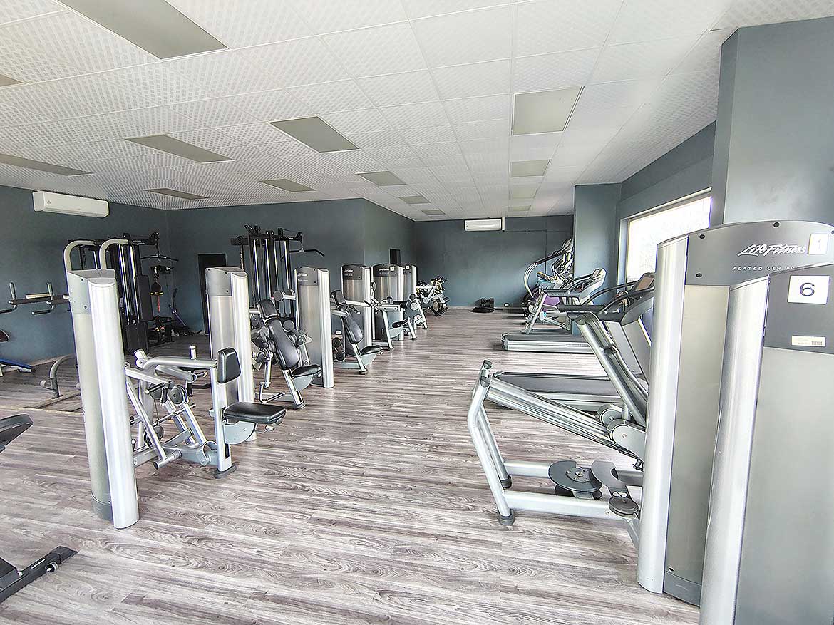 Cornerstone™ Fitness Center at Ella Vista Gardens Modern gym with cardio and strength equipment at Ella Vista Gardens.