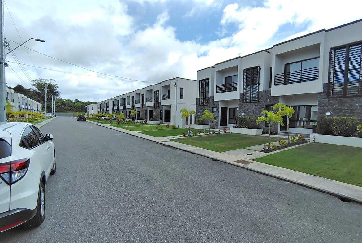 Contemporary townhouses at Ella Vista Gardens with landscaped front yards.