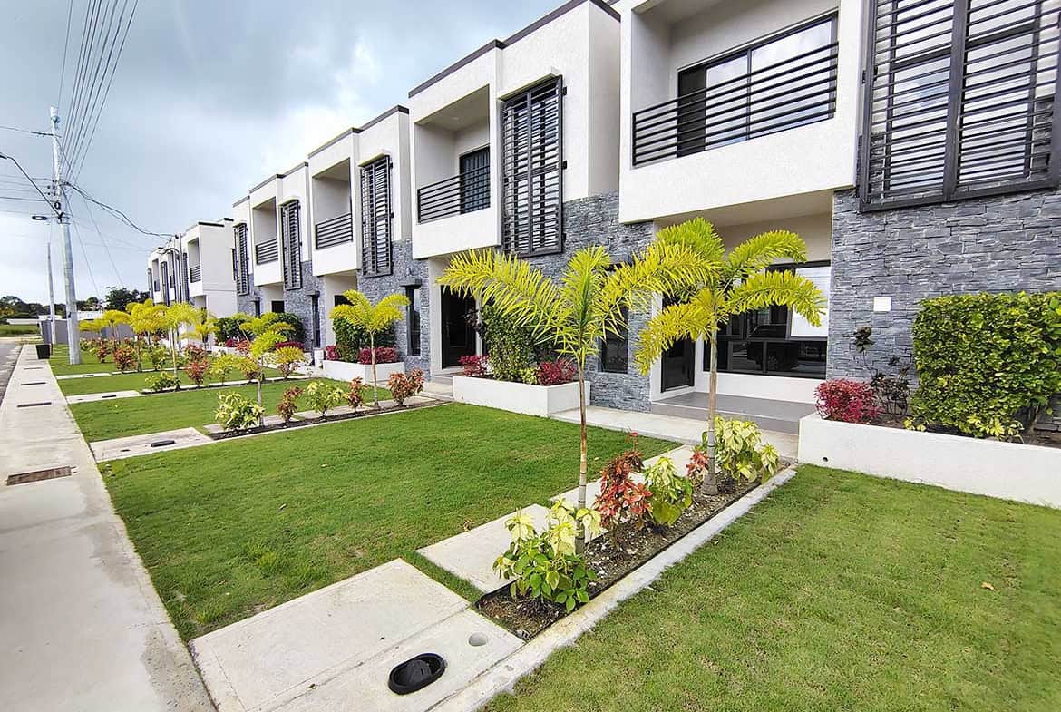 Modern townhouses with lush landscaping at Ella Vista Gardens, Cornerstone.